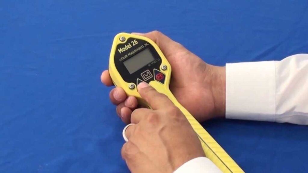 Person operating the model 26 frisker with Geiger Mueller Pancake from Ludlum